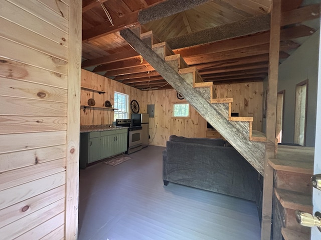 166 Tupper Rd, Madison, ME 04950 - unfurnished living room with stairs, wooden walls, and electric panel