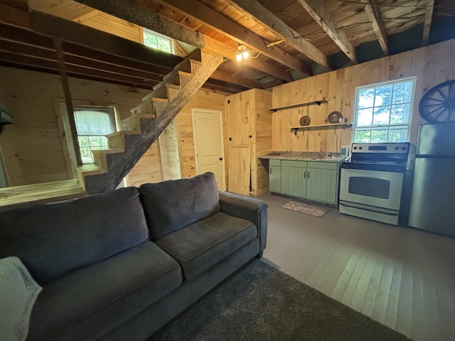 166 Tupper Rd, Madison, ME 04950 - living room featuring wood walls, stairs, and wood finished floors