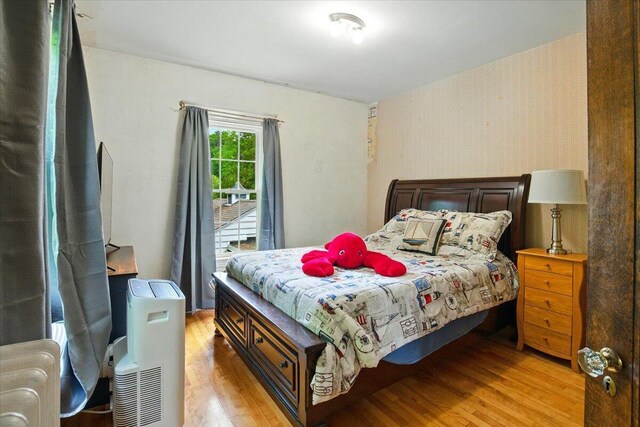 11 Pine Ave, Livermore Falls, ME 04254 - bedroom with light wood-type flooring and wallpapered walls