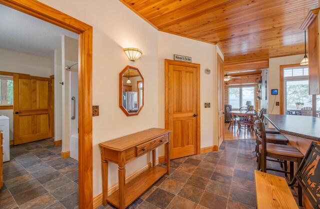 177 Meadow Ln, Smithfield, ME 04978 - hall with wood ceiling, baseboards, washer / clothes dryer, and dark stone finish floors