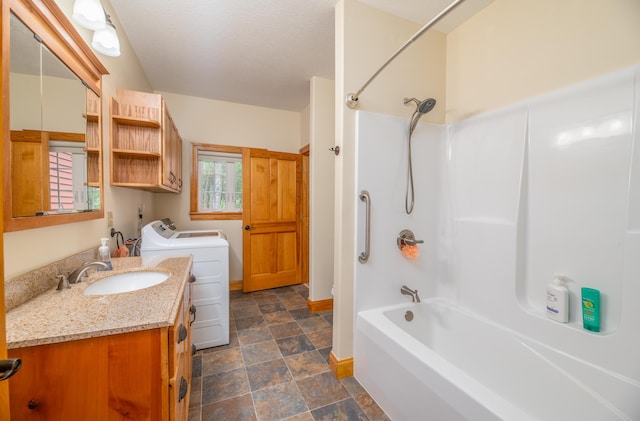 177 Meadow Ln, Smithfield, ME 04978 - bathroom featuring stone finish flooring, tub / shower combination, vanity, washing machine and dryer, and baseboards