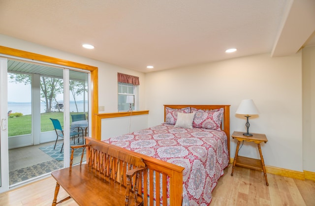 177 Meadow Ln, Smithfield, ME 04978 - bedroom with access to exterior, wood finished floors, a water view, recessed lighting, and baseboards