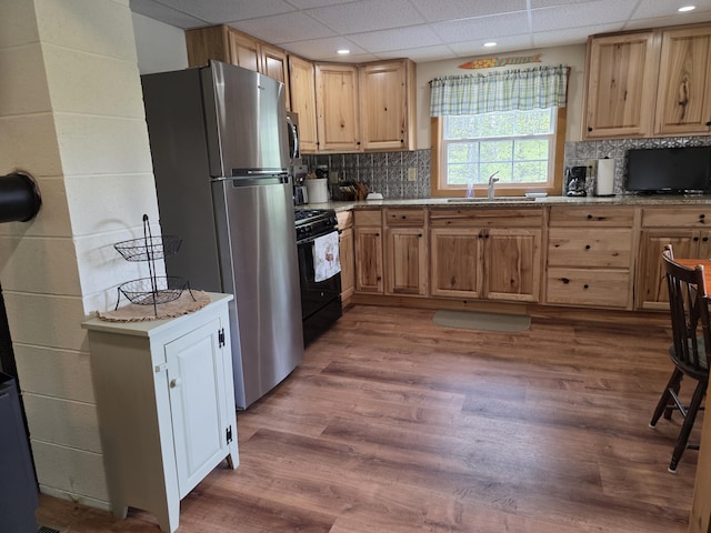 25 Oak Ridge Rd, Shirley, ME 04485 - kitchen featuring appliances with stainless steel finishes, a sink, light brown cabinetry, wood finished floors, and a drop ceiling