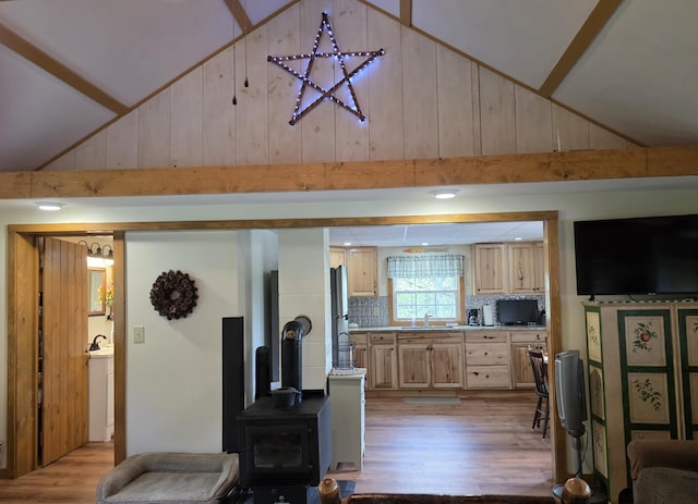 25 Oak Ridge Rd, Shirley, ME 04485 - living area with a wood stove, light wood-style flooring, wooden walls, and high vaulted ceiling