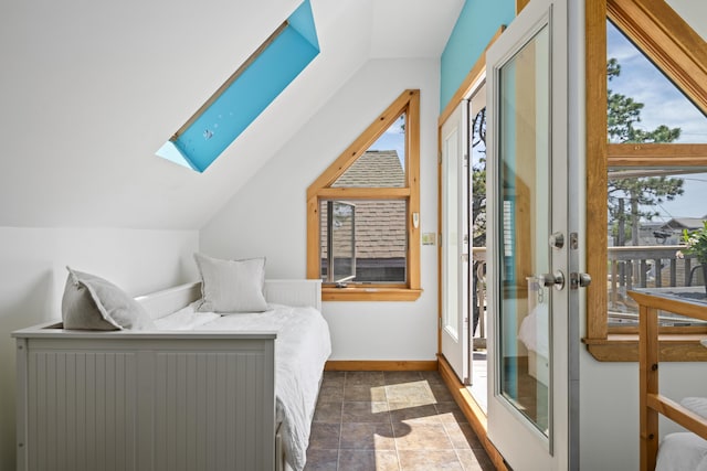 23 N Ave Unit 23, Saco, ME 04072 - bedroom featuring a skylight, vaulted ceiling, baseboards, and dark stone finish flooring