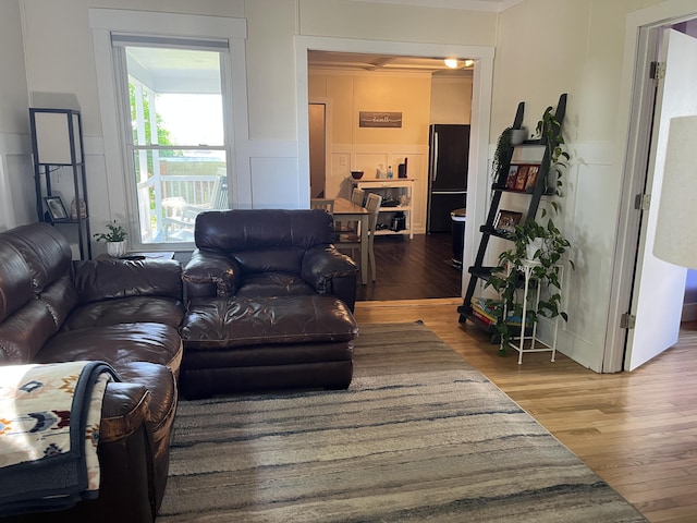6 High St, Waterville, ME 04901 - living area with a decorative wall, wood finished floors, a wainscoted wall, and crown molding