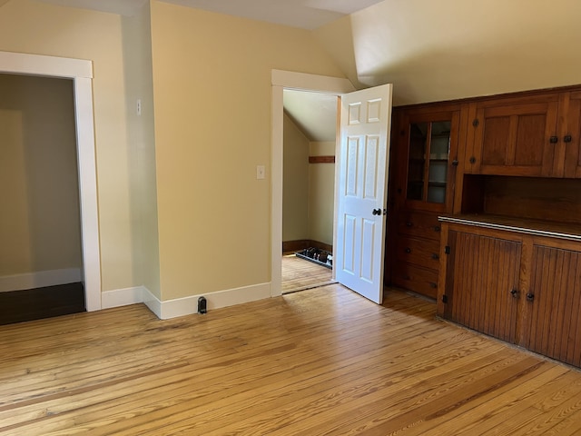 6 High St, Waterville, ME 04901 - empty room with light wood finished floors, lofted ceiling, and baseboards