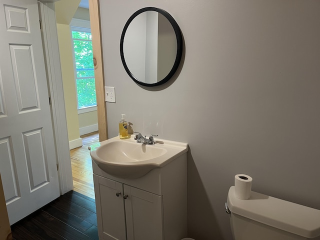 6 High St, Waterville, ME 04901 - half bathroom with toilet, vanity, wood finished floors, and baseboards