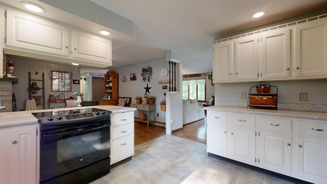 76 Parkview Ave, Livermore Falls, ME 04254 - kitchen with electric range, light countertops, white cabinetry, light floors, and recessed lighting