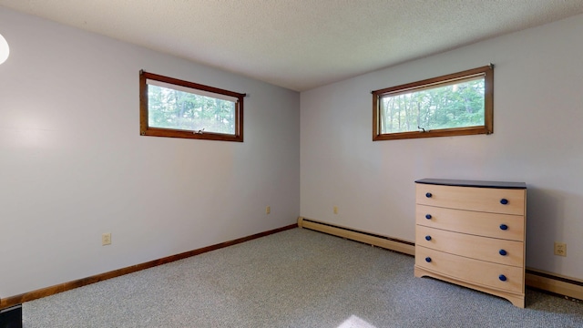 76 Parkview Ave, Livermore Falls, ME 04254 - unfurnished bedroom featuring a baseboard radiator, light carpet, and a textured ceiling