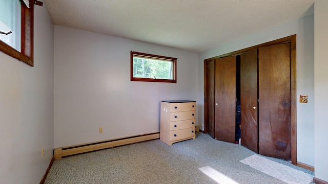 76 Parkview Ave, Livermore Falls, ME 04254 - unfurnished bedroom featuring baseboard heating, carpet, and a closet