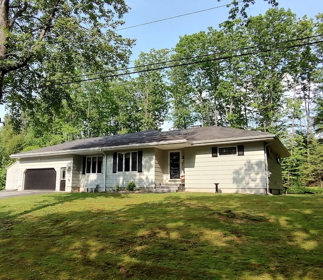 76 Parkview Ave, Livermore Falls, ME 04254 - view of front facade featuring a garage, a front yard, and driveway