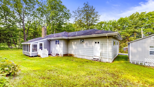 76 Parkview Ave, Livermore Falls, ME 04254 - back of house featuring entry steps, a chimney, a lawn, roof with shingles, and view of scattered trees