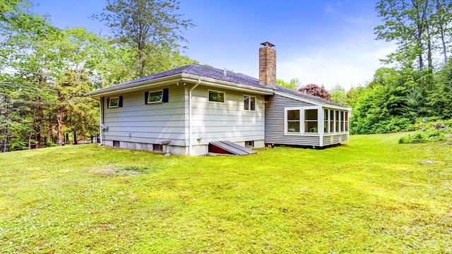 76 Parkview Ave, Livermore Falls, ME 04254 - rear view of property with a chimney and a yard