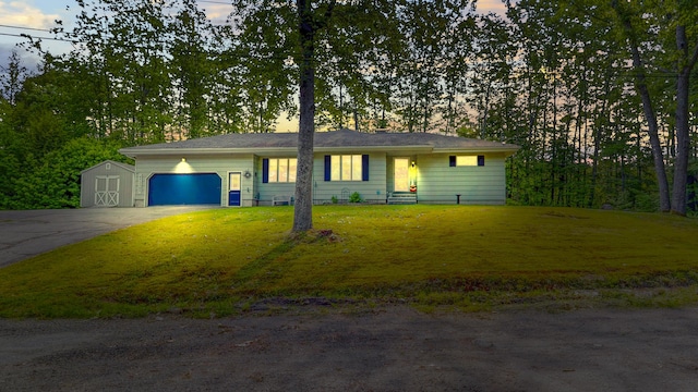 76 Parkview Ave, Livermore Falls, ME 04254 - ranch-style house with an attached garage, driveway, a front lawn, and a storage shed