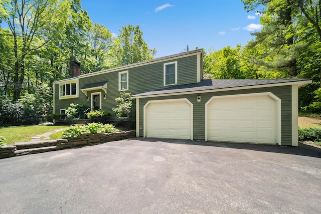 3 Wilson Ln, Saco, ME 04072 - split foyer home with a garage, a chimney, and driveway