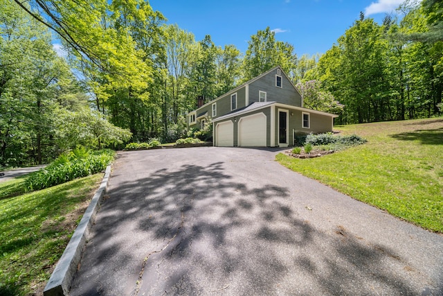 3 Wilson Ln, Saco, ME 04072 - view of side of property featuring asphalt driveway, a lawn, and an attached garage