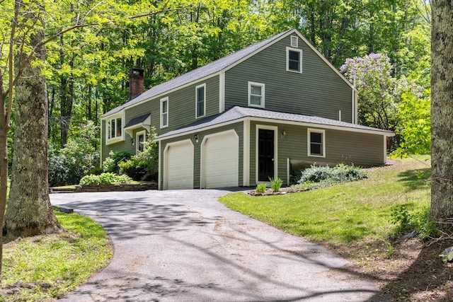 3 Wilson Ln, Saco, ME 04072 - view of front facade featuring a chimney, driveway, an attached garage, a shingled roof, and view of wooded area