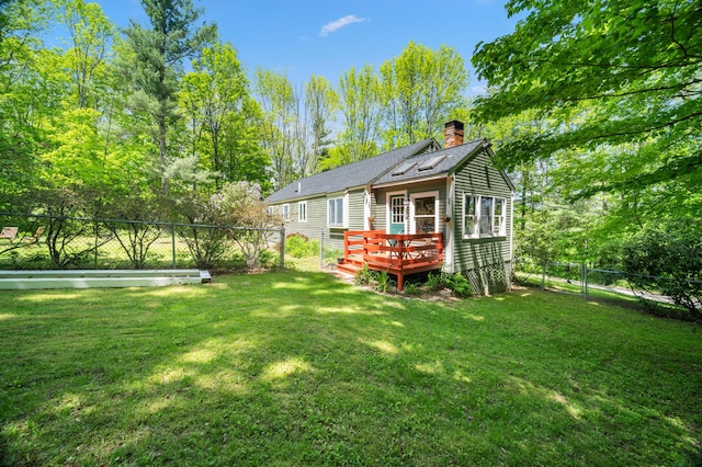 3 Wilson Ln, Saco, ME 04072 - back of house featuring a chimney, a wooden deck, and roof with shingles