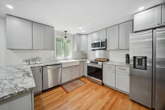 3 Wilson Ln, Saco, ME 04072 - kitchen with appliances with stainless steel finishes, a sink, light wood-style flooring, recessed lighting, and a textured ceiling