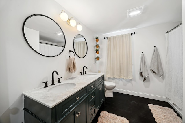 3 Wilson Ln, Saco, ME 04072 - full bathroom with double vanity, baseboards, toilet, and wood finished floors