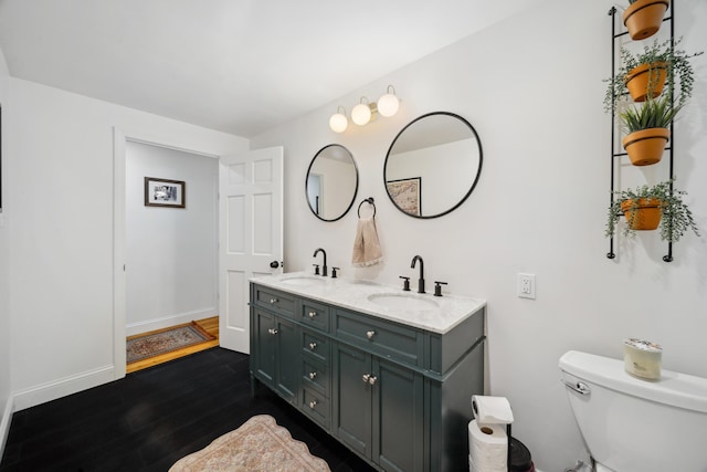 3 Wilson Ln, Saco, ME 04072 - full bath with double vanity, wood finished floors, baseboards, and toilet