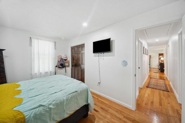 3 Wilson Ln, Saco, ME 04072 - bedroom featuring attic access, light wood-type flooring, and baseboards