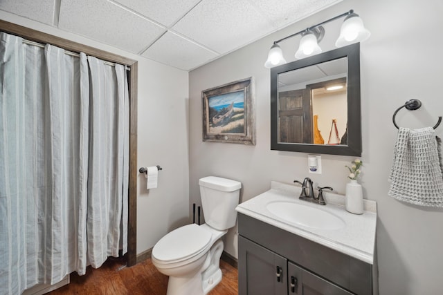 3 Wilson Ln, Saco, ME 04072 - bathroom with wood finished floors, vanity, toilet, a drop ceiling, and baseboards
