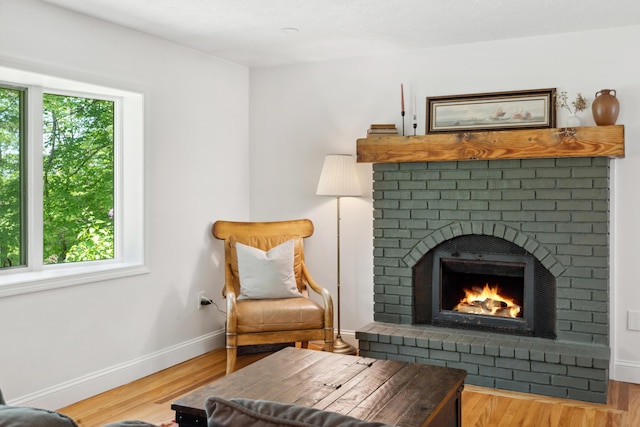 3 Wilson Ln, Saco, ME 04072 - living area featuring baseboards, wood finished floors, and a brick fireplace