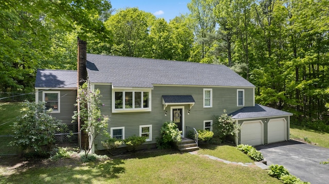 3 Wilson Ln, Saco, ME 04072 - raised ranch featuring a chimney, driveway, roof with shingles, and an attached garage