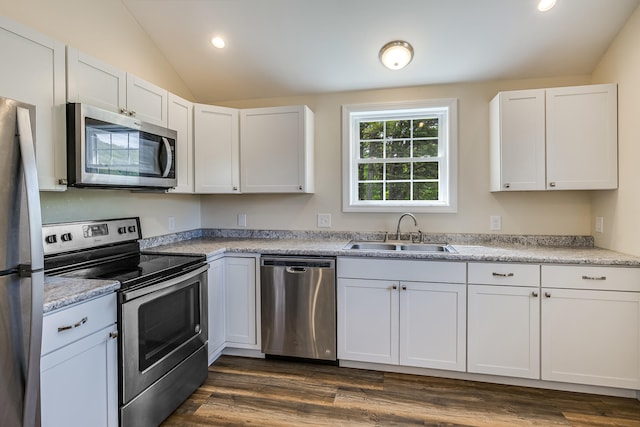 711 Newfield Rd, Shapleigh, ME 04076 - kitchen featuring stainless steel appliances, a sink, white cabinetry, vaulted ceiling, and dark wood-style floors
