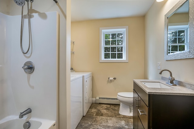 711 Newfield Rd, Shapleigh, ME 04076 - bathroom featuring separate washer and dryer, a baseboard heating unit, vanity, toilet, and tub / shower combination