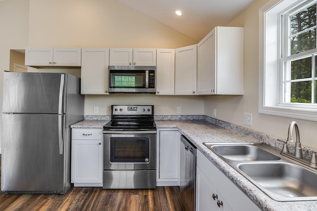 711 Newfield Rd, Shapleigh, ME 04076 - kitchen featuring stainless steel appliances, a sink, vaulted ceiling, light countertops, and white cabinets
