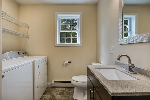 711 Newfield Rd, Shapleigh, ME 04076 - bathroom featuring a baseboard heating unit, washing machine and clothes dryer, vanity, toilet, and baseboards