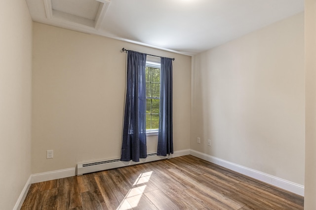 711 Newfield Rd, Shapleigh, ME 04076 - unfurnished room with wood finished floors, baseboards, attic access, and a baseboard heating unit