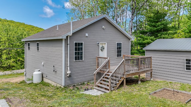 711 Newfield Rd, Shapleigh, ME 04076 - back of property featuring a wooden deck, a yard, roof with shingles, and stairway