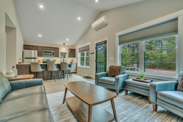 69 Bernier Ln, Waterboro, ME 04087 - living room with a wall unit AC, light wood finished floors, recessed lighting, and high vaulted ceiling