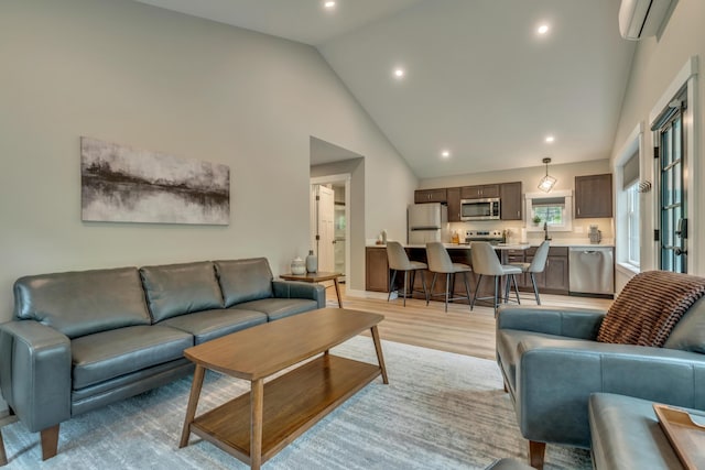 69 Bernier Ln, Waterboro, ME 04087 - living room featuring a wall unit AC, recessed lighting, light wood finished floors, and high vaulted ceiling