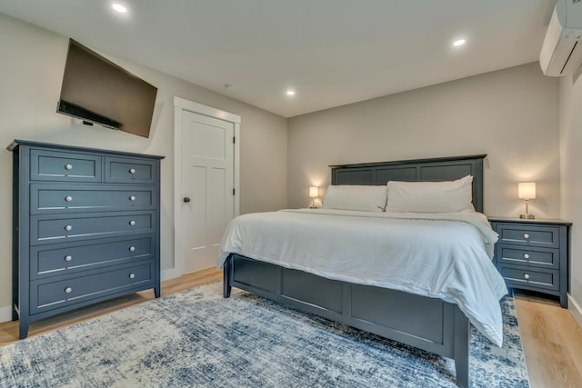 69 Bernier Ln, Waterboro, ME 04087 - bedroom with a wall mounted AC, light wood-style floors, recessed lighting, and baseboards