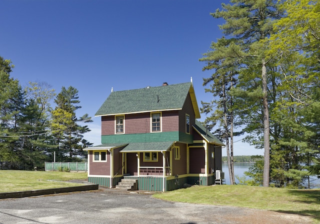 33 Houghton Pond Rd, West Bath, ME 04530 - view of front facade featuring covered porch, a shingled roof, a water view, a front lawn, and a chimney