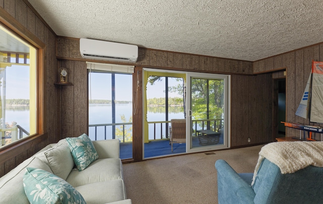33 Houghton Pond Rd, West Bath, ME 04530 - living room featuring a wall mounted AC, carpet, a water view, wood walls, and a textured ceiling