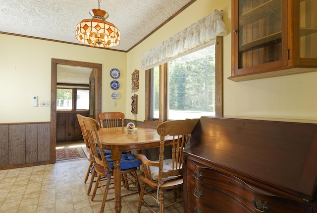 33 Houghton Pond Rd, West Bath, ME 04530 - dining area with ornamental molding, a textured ceiling, and wainscoting