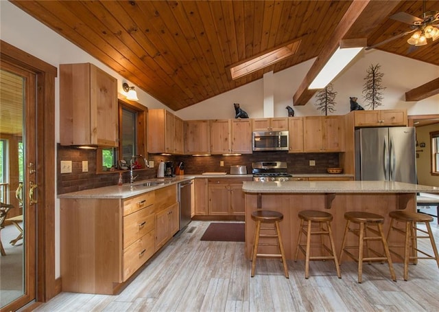 81 Bryers Cir, Boothbay, ME 04537 - kitchen with appliances with stainless steel finishes, wooden ceiling, lofted ceiling, light wood-style flooring, and a kitchen breakfast bar