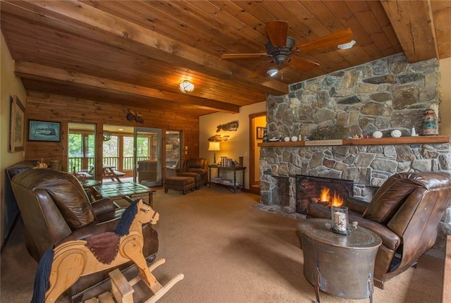 81 Bryers Cir, Boothbay, ME 04537 - carpeted living area with a wooden ceiling with exposed beams, a ceiling fan, and a stone fireplace