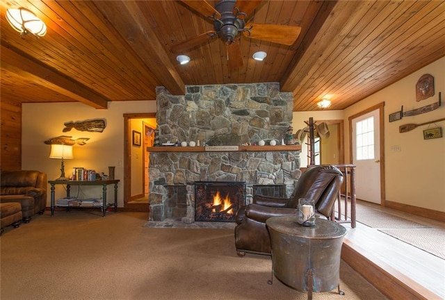 81 Bryers Cir, Boothbay, ME 04537 - living area with a wooden ceiling with exposed beams, a stone fireplace, a ceiling fan, and carpet