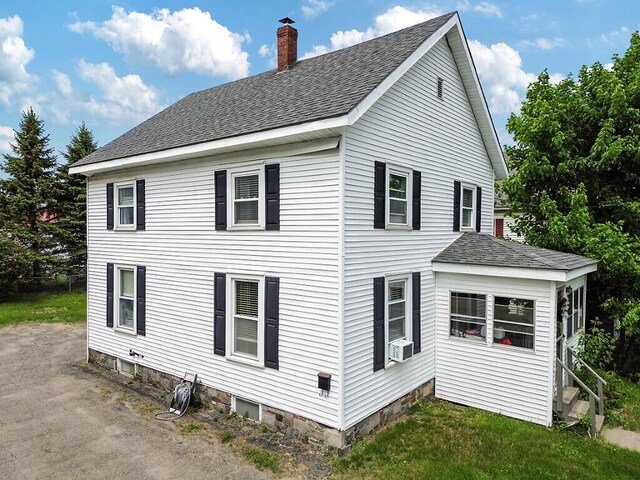 128 Benton Ave, Winslow, ME 04901 - view of property exterior featuring a shingled roof, a chimney, and cooling unit