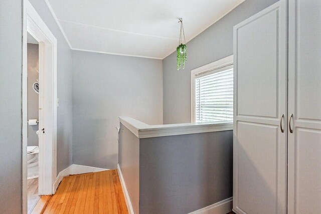 128 Benton Ave, Winslow, ME 04901 - hall with light wood-style flooring, baseboards, an upstairs landing, and crown molding