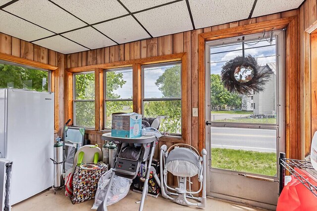128 Benton Ave, Winslow, ME 04901 - sunroom with wood walls, concrete flooring, and a paneled ceiling