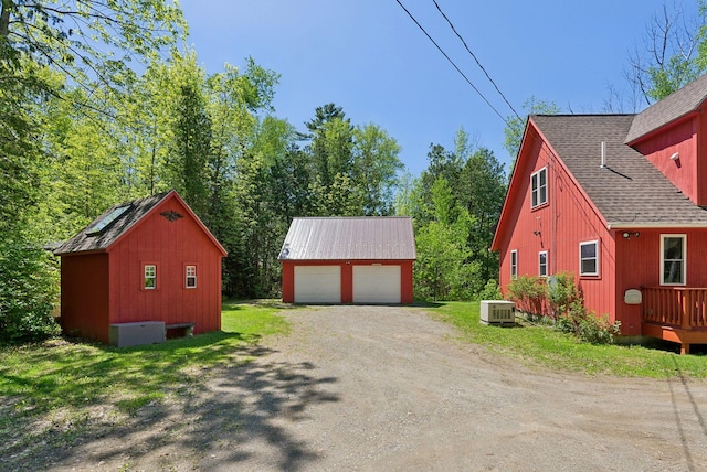 80 Hart St, Newport, ME 04953 - view of property exterior with an outdoor structure, a detached garage, and a shingled roof