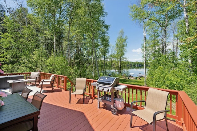 80 Hart St, Newport, ME 04953 - wooden terrace with a water view, grilling area, a fire pit, and outdoor dining area